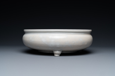 Un br&ucirc;le-parfum tripod &agrave; d&eacute;cor floral incis&eacute; en porcelaine blanc de Chine de Dehua sur socle en bois, Kangxi