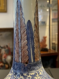 A Chinese blue, white and copper-red bottle vase with a deer and birds among blossoming branches, Daoguang