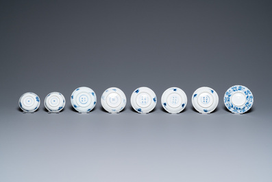 Twenty-seven Chinese blue and white saucers and seven cups, Kangxi and later