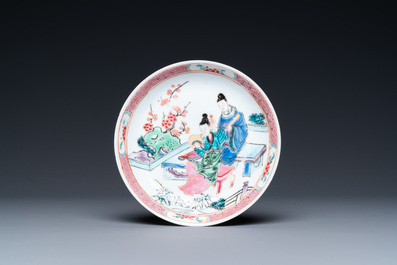 A Chinese famille rose cup and saucer with a couple on a terrace, Qianlong