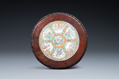 A Chinese wooden table with a Canton famille rose plaque, 19th C.