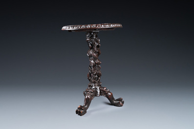 A Chinese wooden table with a Canton famille rose plaque, 19th C.
