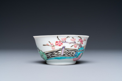 A Chinese famille rose cup and saucer with a couple on a terrace, Qianlong