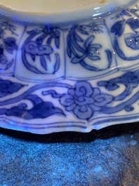 Three Chinese blue and white lotus-shaped 'acupuncture' cups and saucers, Kangxi