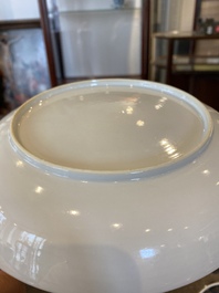A fine Chinese famille rose plate with a mother, her son and their servant in an interior, Yongzheng