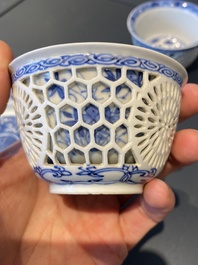 A pair of Chinese blue and white reticulated double-walled cups and saucers, Kangxi