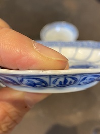 Three Chinese blue and white lotus-shaped 'acupuncture' cups and saucers, Kangxi