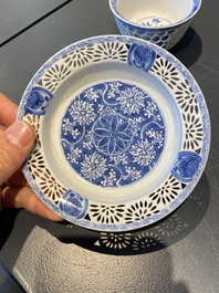 A pair of Chinese blue and white reticulated double-walled cups and saucers, Kangxi