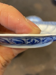 Three Chinese blue and white lotus-shaped 'acupuncture' cups and saucers, Kangxi