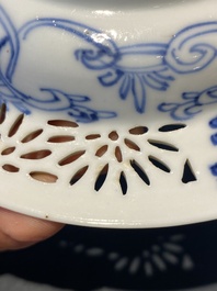 A pair of Chinese blue and white reticulated double-walled cups and saucers, Kangxi
