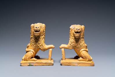 A pair of Flemish or North-French pottery lions, signed and dated 1865