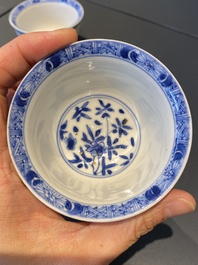 A pair of Chinese blue and white reticulated double-walled cups and saucers, Kangxi