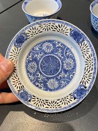 A pair of Chinese blue and white reticulated double-walled cups and saucers, Kangxi