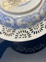 A pair of Chinese blue and white reticulated double-walled cups and saucers, Kangxi