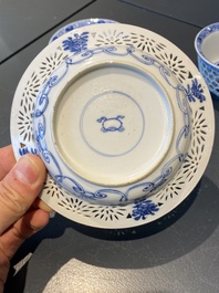 A pair of Chinese blue and white reticulated double-walled cups and saucers, Kangxi