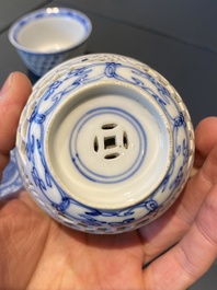 A pair of Chinese blue and white reticulated double-walled cups and saucers, Kangxi