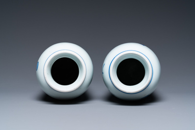 A pair of Chinese blue and white rouleau vases with birds among blossoming branches, Transitional period