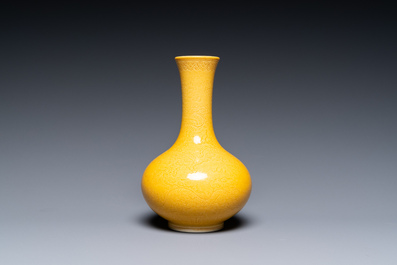 A Chinese monochrome yellow-glazed bottle vase with incised dragon design, Daoguang mark, 19/20th C.