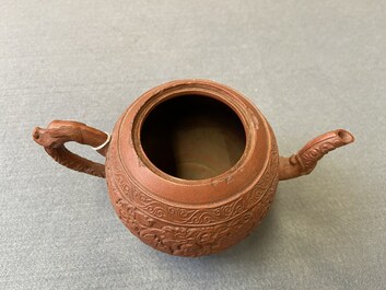 A Chinese Yixing stoneware teapot with boys among peony scrolls, Kangxi