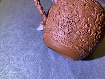 A Chinese Yixing stoneware teapot with boys among peony scrolls, Kangxi