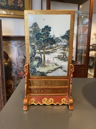 A Chinese famille rose table screen with a winter landscape and a scene with Europeans, various seals, Qianlong mark, 18/19th C.