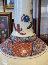A Chinese blue, white and copper red 'antiquities' bottle vase, Qianlong