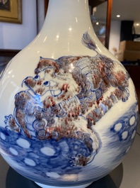 A Chinese blue, white and copper-red bottle vase with Buddhist lions, 20th C.