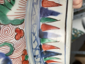 A pair of Chinese wucai 'galloping horses' vases and covers, Transitional period