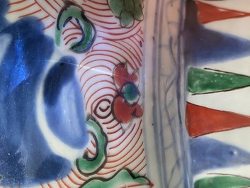 A pair of Chinese wucai 'galloping horses' vases and covers, Transitional period