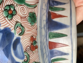 A pair of Chinese wucai 'galloping horses' vases and covers, Transitional period