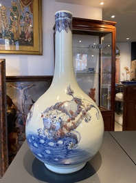 A Chinese blue, white and copper-red bottle vase with Buddhist lions, 20th C.
