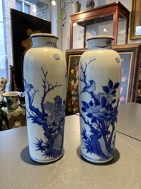 A pair of Chinese blue and white rouleau vases with birds among blossoming branches, Transitional period