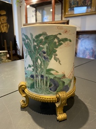 A Chinese famille verte brush pot on gilt bronze stand, Kangxi