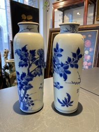 A pair of Chinese blue and white rouleau vases with birds among blossoming branches, Transitional period