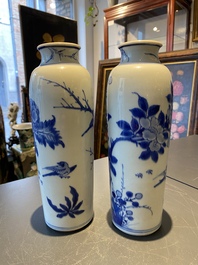 A pair of Chinese blue and white rouleau vases with birds among blossoming branches, Transitional period