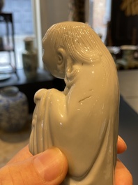 A Chinese Dehua blanc de Chine figure of Liu Hai with the toad, Kangxi