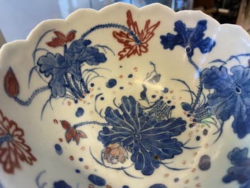 A pair of Chinese blue, white and copper-red 'lotus' bowls, Kangxi mark, 19th C.