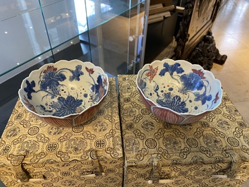 A pair of Chinese blue, white and copper-red 'lotus' bowls, Kangxi mark, 19th C.