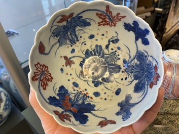 A pair of Chinese blue, white and copper-red 'lotus' bowls, Kangxi mark, 19th C.