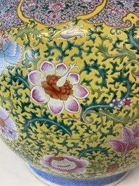 A large Chinese famille rose yellow-ground fish bowl with fine floral scrolls, 19th C.