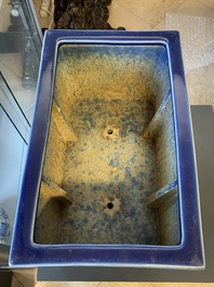 A Chinese rectangular blue-glazed jardini&egrave;re on wooden stand, 19th C.