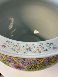 A large Chinese famille rose yellow-ground fish bowl with fine floral scrolls, 19th C.