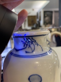 A pair of Chinese blue and white rouleau vases with birds among blossoming branches, Transitional period
