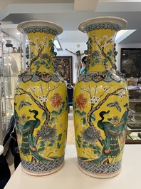 A pair of Chinese yellow-ground famille rose vases, 19th C.