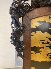 A large Japanese wooden screen with a central gilt-lacquered and ivory-inlaid panel, Meiji
