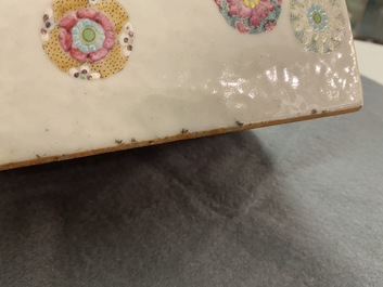 A Chinese famille rose neck pillow with floral balls, 19th C.