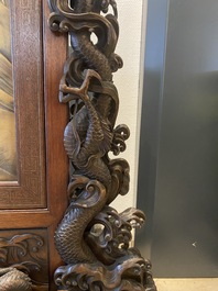A large Japanese wooden screen with a central gilt-lacquered and ivory-inlaid panel, Meiji