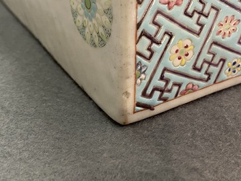 A Chinese famille rose neck pillow with floral balls, 19th C.
