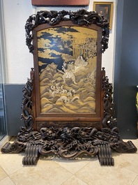 A large Japanese wooden screen with a central gilt-lacquered and ivory-inlaid panel, Meiji