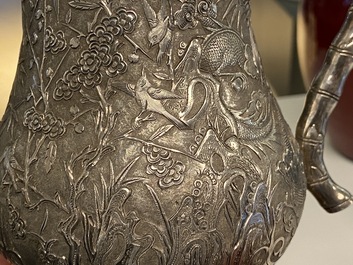 A Chinese silver teapot with birds among blossoming branches, 19th C.